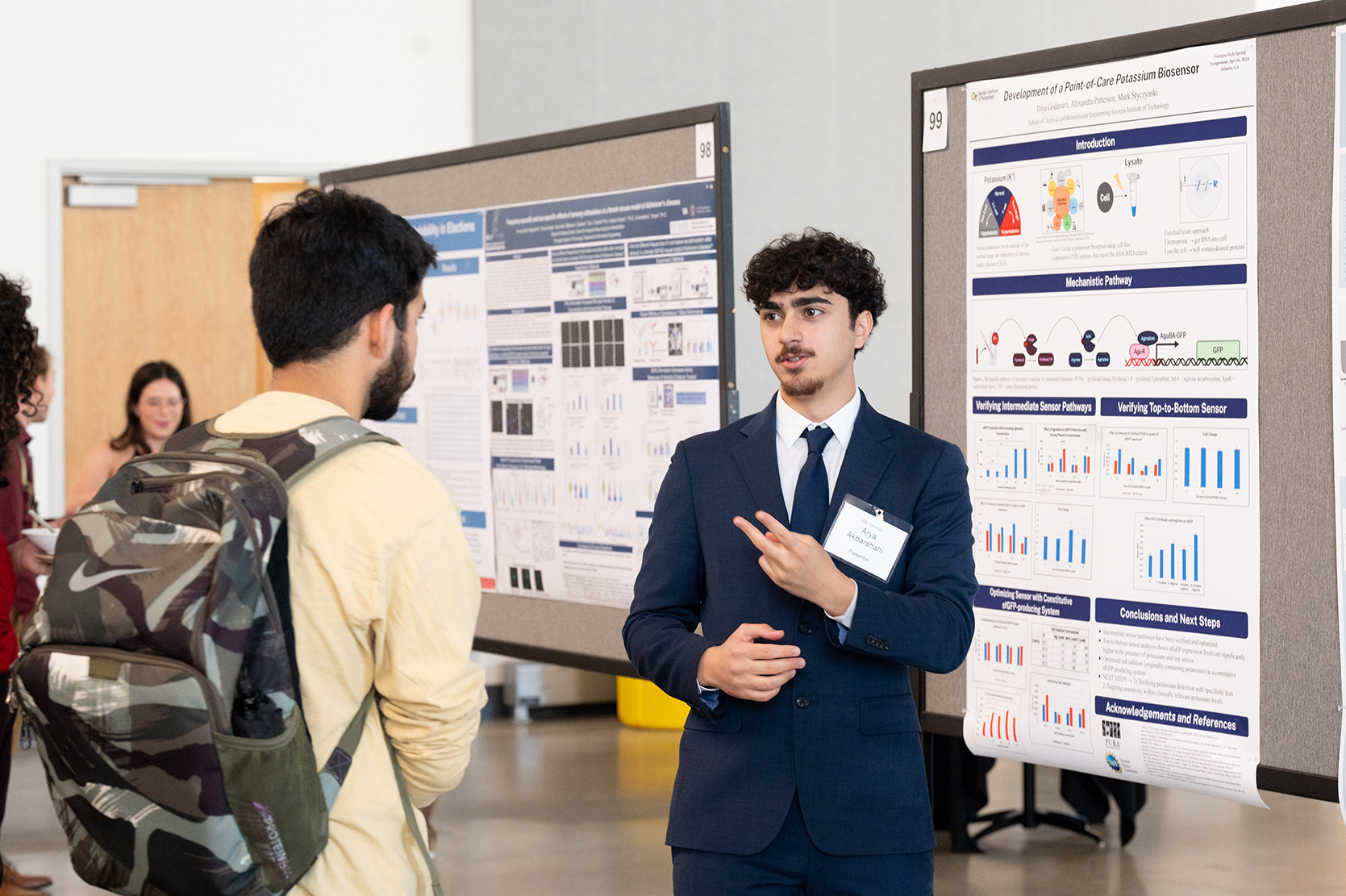 Student researcher presents during the poster session at Undergraduate Research Spring Symposium.