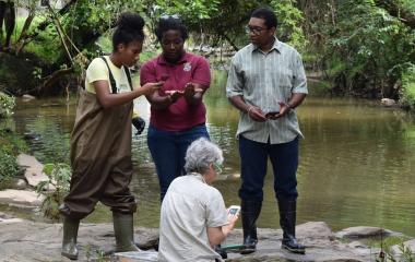 students standing near a creek