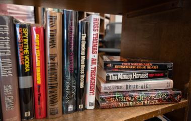 A collection of books on a library shelf.