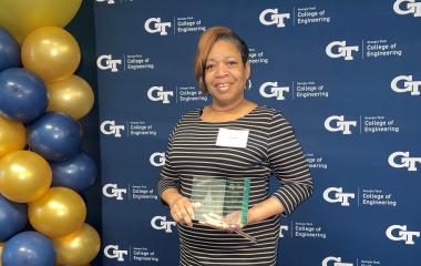 Lynn Isaac receiving an award after completing the Georgia Tech SOAR program.