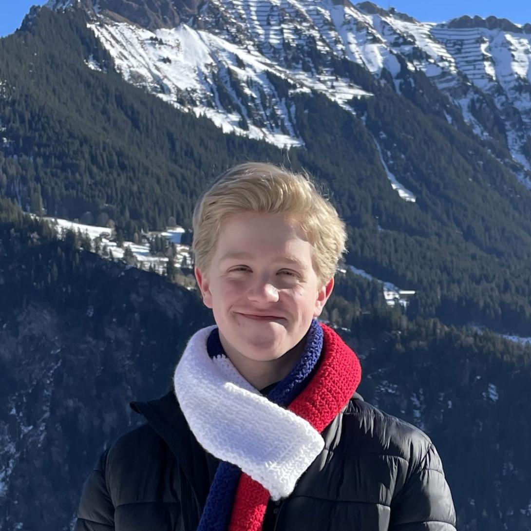 headshot of porter zach in front of mountains