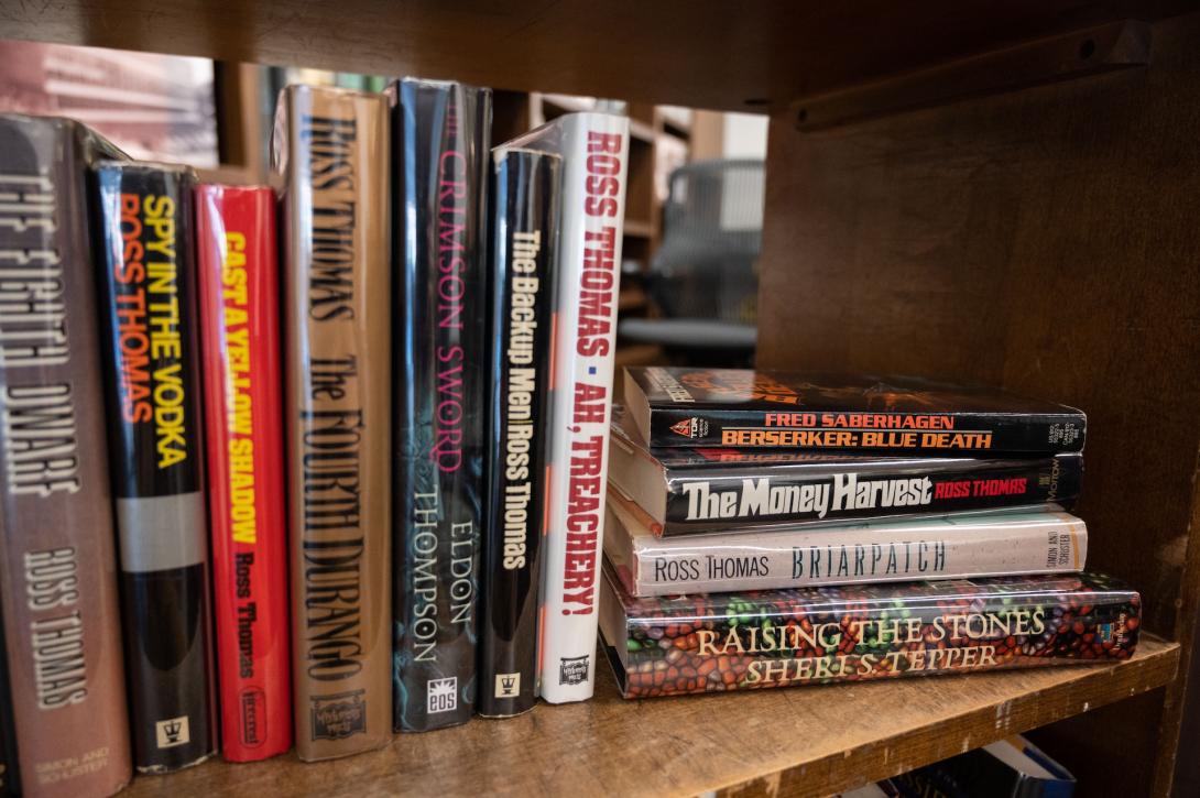 A collection of books on a library shelf.